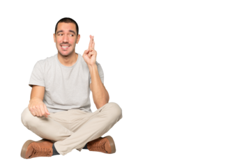 Concerned young man doing a crossed fingers gesture