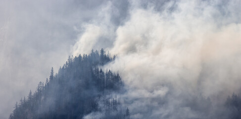 BC Forest Fire and Smoke over the mountain near Hope during a hot sunny summer day. British Columbia, Canada. Wildfire natural disaster