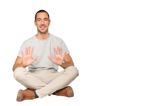 Young man making a number ten gesture