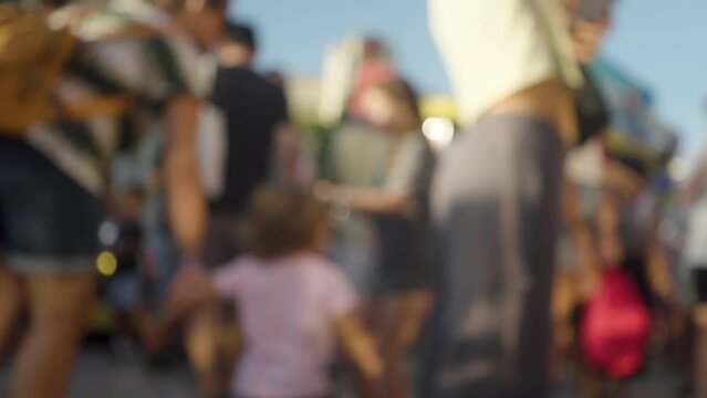 A blurred crowd walking at a funfair