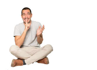 Amazed young man asking for silence gesturing with his finger