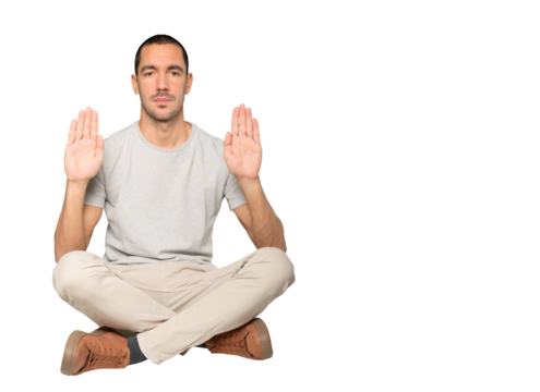 Serious young man making a gesture of stop with his palm