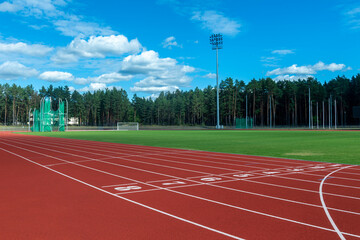 Red running track in stadium. Sport theme background. Horizontal sport theme poster, greeting cards, headers, website and app