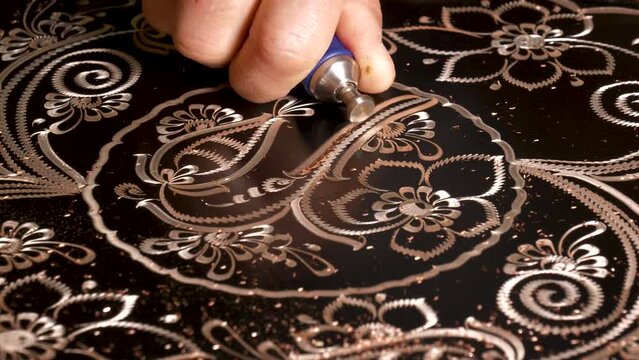 Handicrafts. Traditional motifs embroidered on copper with various tools, copper ornament art. Engraving eye-catching patterns on copper.