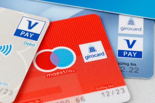 Girocards with maestro and v pay payment option. Selective focus on girocard word on sign logo. German bank cards.
