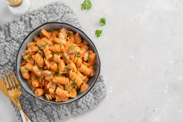 Fusilli pasta with chicken. Cooked in spicy sauce from tomatoes, onion, garlic with chicken meat