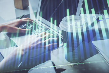Double exposure of woman hands typing on computer and forex chart hologram drawing. Stock market invest concept.