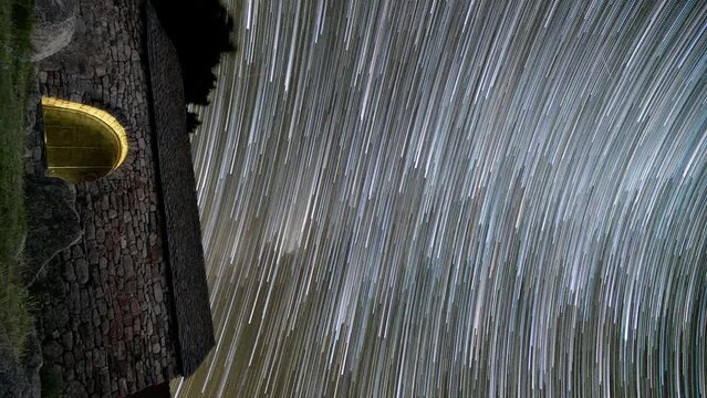 vertical video timelapse of romanesque hermitage of Sant Quirc under star trails