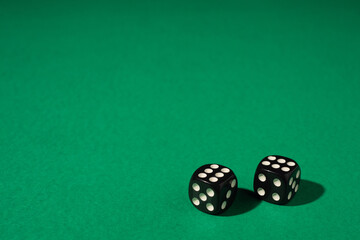 Dice for gambling on a green playing table. Place for the inscription. copy space