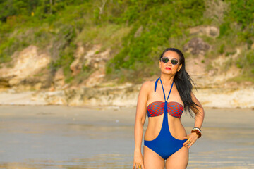 Fototapeta na wymiar Woman body pretty stand smile with swimsuit at beach