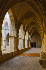 Arched corridor in courtyard of Cathedral of Saint Nazaire, Beziers, France