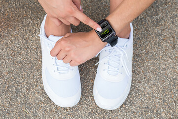 Female Athlete Touching At Smart Watch Showing Heartbeat Rate