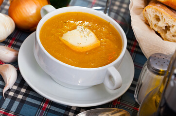 Appetizing vegetable soup puree served with cheese in bowl