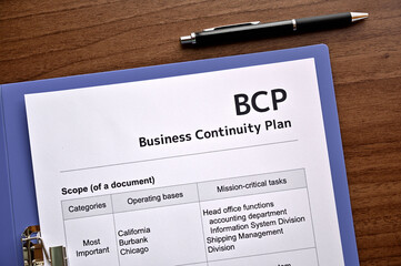 There is dummy documents that created for the photo shoot on the desk about Business Continuity Plan.
