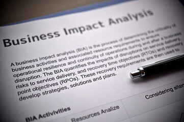 There is dummy documents that created for the photo shoot on the desk about Business Impact Analysis.