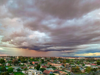 Panoramic aerial Drone view of Melbournes suburbs and CBD looking down at Houses roads and Parks Victoria Australia. Beautiful colours at Sunset