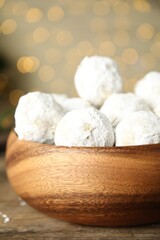 Fototapeta na wymiar Tasty snowball cookies in wooden bowl, closeup. Christmas treat