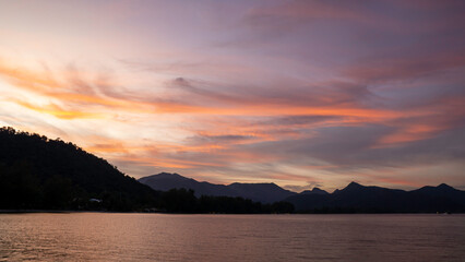 Fototapeta premium Beautiful sunset clouds view over the mountain view.