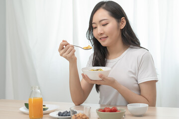 young female planning menu to eat ketogenic diet during weight loss program.