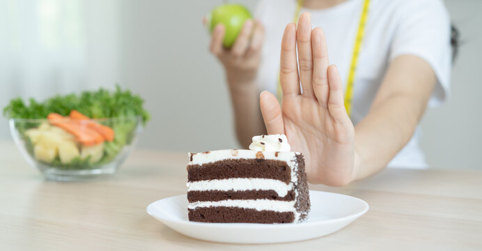 eat less sugar for health, women avoid to eat chocolate cake and sweets during sugar diet session for lose weight