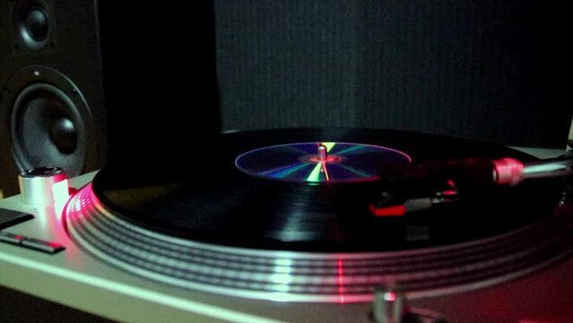  turntable with vinyl plate.stylus on record, close-up in dim lighting, studio atmosphere