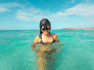 Beautiful woman snorkeling on the beach