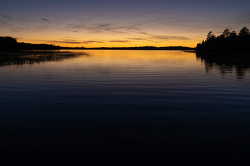 Naklejka premium Fading sunset glow at dusk over northern lake scene for magazine newsletter advertising layout design