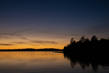 Obraz na płótnie Canvas Fading sunset glow at dusk over northern lake scene for magazine newsletter advertising layout design