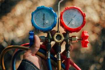 man holding air conditioner gauge