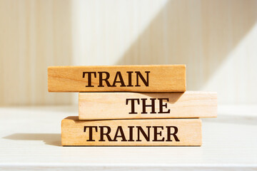 Wooden blocks with words 'Train The Trainer'.