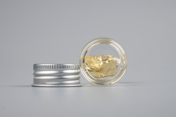 piace cannabis extract wax with transparent bottle closeup on gray background