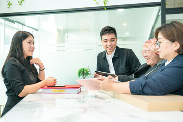Friendly colleagues work team working together, laughing with positive emotions in the office.