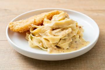 fettuccine pasta white cream sauce with fried fish