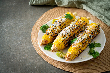 barbecue and grilled corn with cheese and lime