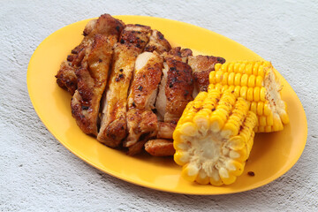 Freshly cooked grilled chicken served with corn