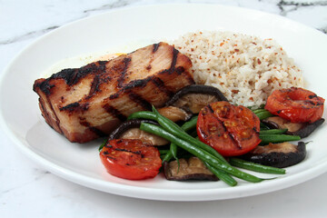 Freshly cooked grilled tuna fish served with rice and vegetables