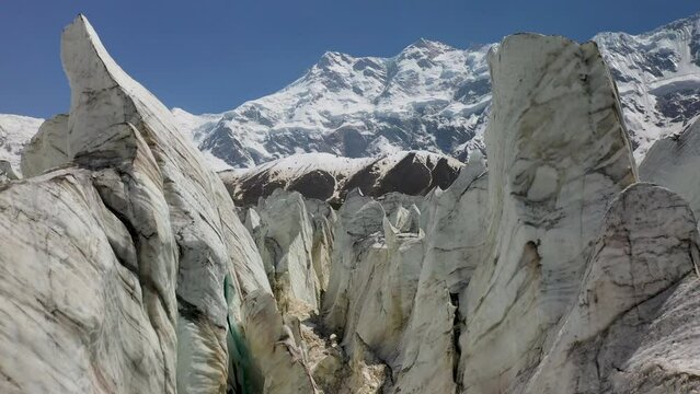 Aerial shot of flying through the glacier walls with Nanga Parbat in the background, Fairy Meadows Pakistan, cinematic drone shot