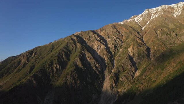 Drone shot of sun setting on Nanga Parbat, Fairy Meadows Pakistan, high mountains, cinematic aerial shot