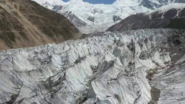 Drone shot of descending toward glacier canyons with Nanga Parbat in the background, Fairy Meadows Pakistan, cinematic aerial shot