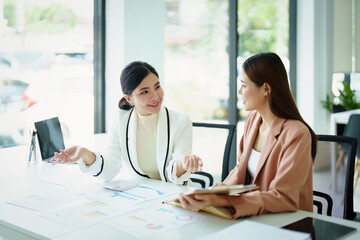 Fototapeta premium marketing employee and a salesperson using product documentation to plan sales.