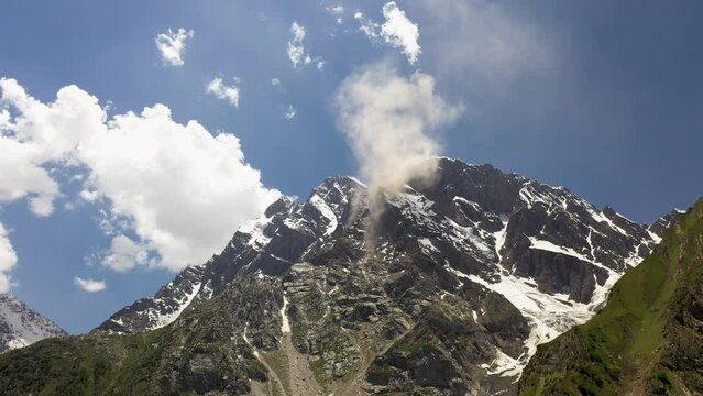 Aerial shot of Nanga Parbat, Fairy Meadows Pakistan, looking up towards a mountain peak with clouds coming off ridge, cinematic drone shot