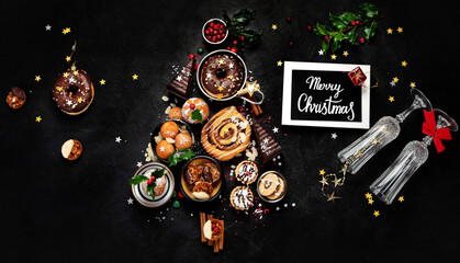 Christmas tree with sweets and cookies decoration on dark background.