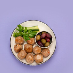 Greek meatballs keftedes on color background.
