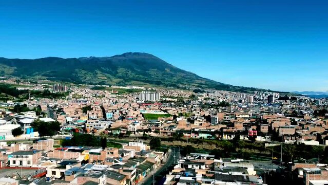 Drone images of a sunny morning in the City of Pasto in Colombia with the Galeras volcano in the background