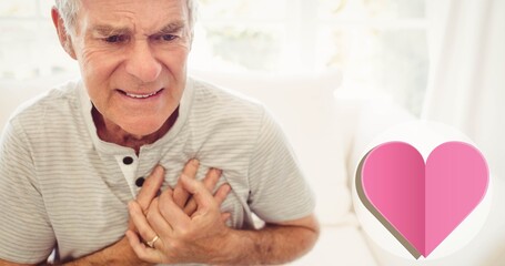 Close-up of caucasian senior man with hands on chest suffering from heart attack