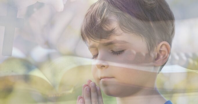 Multiple Exposure Of Caucasian Boy Praying With Hand Holding Rosary On Bible In Background