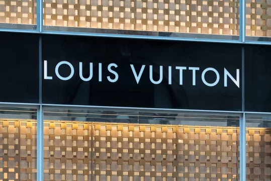 LOUIS VUITTON logo on black surface. Louis Vuitton Malletier
