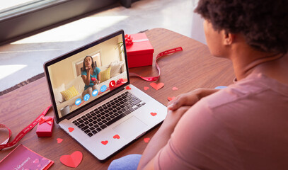 Biracial young woman blowing kiss to african american boyfriend while online dating