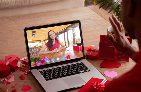 Happy biracial young woman online dating with boyfriend on valentine day