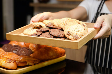 A woman sells sweets, cookies and a bakery in a coffee shop. Small business SME